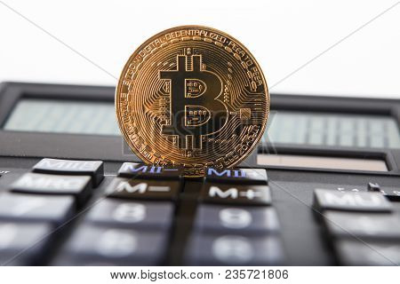 Bitcoin On The Keyboard Of The Calculator. Shallow Depth Of Field. A Visual Representation Of Digita