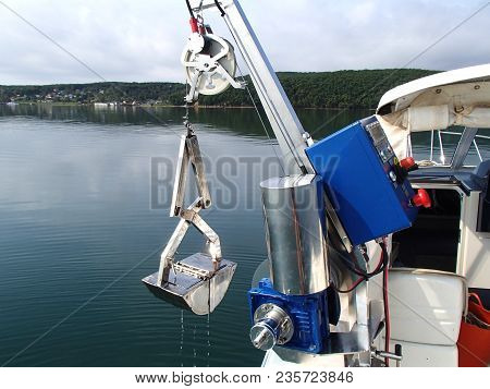Research winch recovering benthic grab with sample from the sea bottom