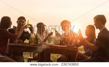 Group Of 6 Teenager Have Dinner Party Celebrating At Sunset With Beautiful Landscape Background