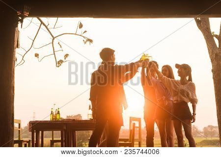Group Of 6 Teenager Have Dinner Party Celebrating At Sunset With Beautiful Landscape Background