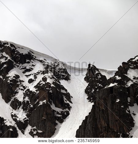 Rock With Snow Cornice In Gray Day. Turkey, Kachkar, Highest Part Of Pontic Mountains.