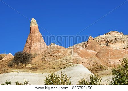 Cappadocia Landscape. Fairy Chimneys In Cappadocia In Red Rose Valley. Deep Blue Sky Over Fungous Fo