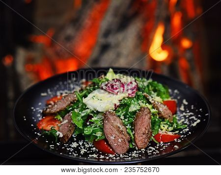 Dish Of Beef Or Veal Served With Lettuce Leaves, Tomatoes And Sprinkled With Parmesan Cheese, Fire O