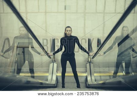 Sexy Girl In Dark Outfit Standing On Escalator. Woman With Slim Body In Metro. Girl Looks Sexi, Desi