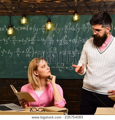 College And Education Concept. Girl Student Listening Bearded Teacher, Lecturer, Professor. Student,