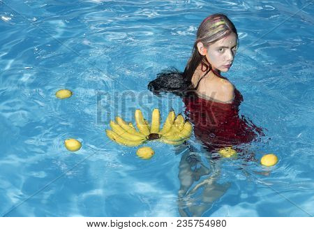 Summer Vacation And Travel To Ocean. Vitamin In Banana At Girl Sitting Near Water. Woman Relax In Sp