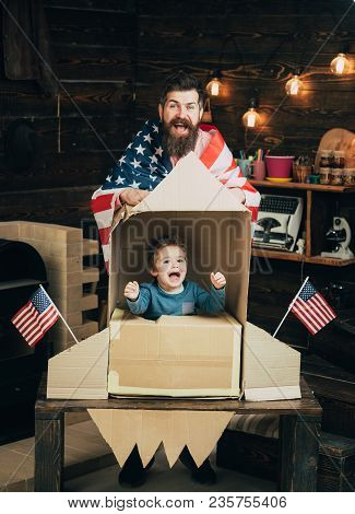 American Cheerful Family With Usa Flags Play With Rocket Made Out Of Cardboard Box. Rocket Launch Co