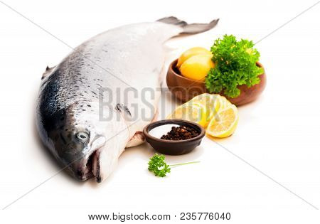 Close  Up On A Whole Rawsalmon With Lemon And Salt Isolated On White