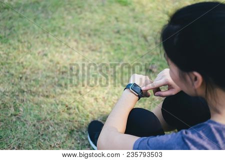 Young Woman Checking Progress On Smart Watch.