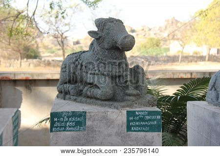 Nandi Stone Lies In The Open-air Museum In Hampi, India. Stone Sculpture. Sacred Cow Stone Sculpture