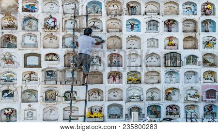 Ica, Peru - August 2017: A Keeper Is Taking Care Of The Above The Ground Tombs In The Ica Cemetery I