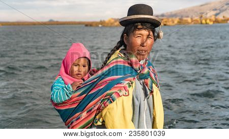 Puno, Peru - September 2017: Unidentified Woman And Her Baby At The Floating Island Isla Flotante, T
