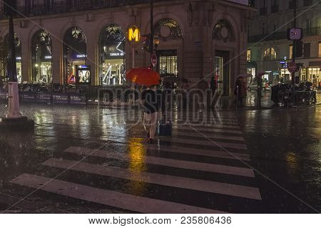 Paris, France - December 10, 2017: People Cross The Street In The Pouring Rain. Paris, Boulevard Hau