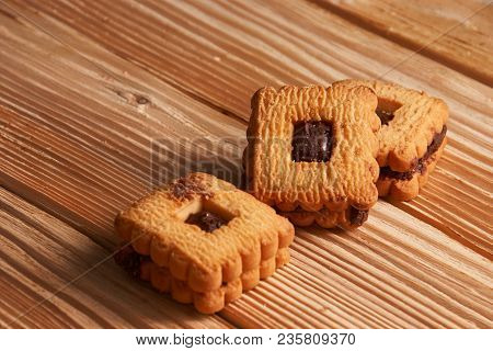 Stacked Chocolate Chip Cookies On A Light Wooden Background