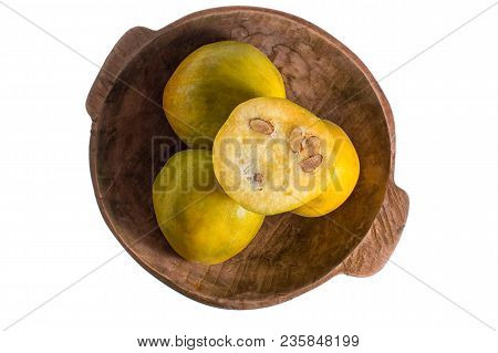 Closeup Of Rare Araza Fruit From The Amazon Area In Rustic Wood Bowl Isolated On White