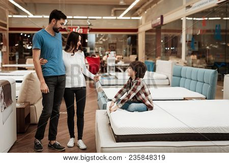 Happy Family With Little Son Came In Furniture Store To Buy Mattress. Choosing Mattress In Store. Yo
