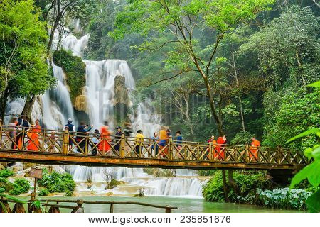 Luangprabang, Laos - December 8, 2015: Tourists On Wooden Bridge Sightseeing Kuang Si Waterfalls In 