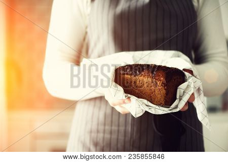 Woman Hands Holding Freshly Baked Bread. Handmade Brown Loaf Of Bread, Bakery Concept, Homemade Food