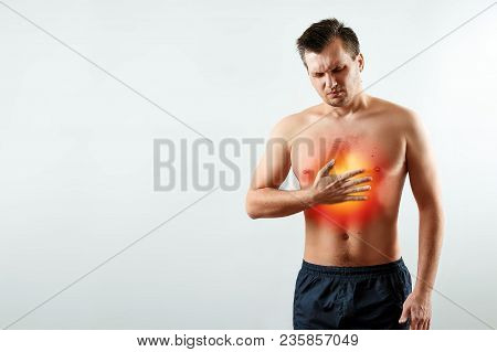 A Man Holds His Hands And Region Of The Heart, Chest Pain, A Pain In The Heart Highlighted In Red, A