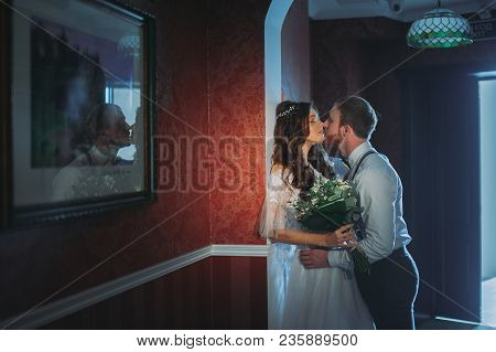Happy Bride And Bearded Groom On The Wedding Walk In The Modern Hotel Hall On Wedding