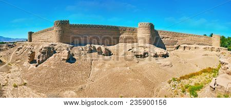 Panorama Of Ancient Deserted Adobe Citadel With Massive Defensive Walls, Numerous Watchtowers And Ro