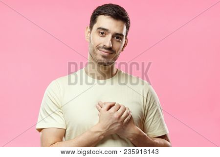 Kind Hearted Friendly Nice Guy Shows Kindness, Wearing Blank Biege T-shirt. Portrait Of Smiling Posi
