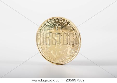 Golden Bitcoin On Isolated On White Table. A Visual Representation Of Digital Cryptocurrencies. Bitc