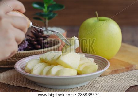 Use Fork Skewered On A Piece Of Ready To Eat Fresh Shinano Gold Apple. Delicious Yellow Apple On Pla