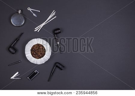 Different Smoking Tobacco Pipes, Tobacco In The Can And Tobacco Accessories On Dark Background With 
