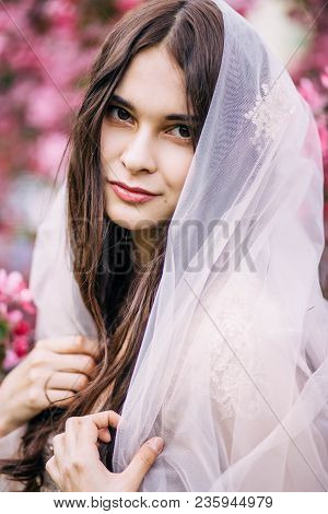 Beautiful Girl Bride Brunette Closed The Veil To The Hair, And Looks With A Smile, Happy, Closeup, O