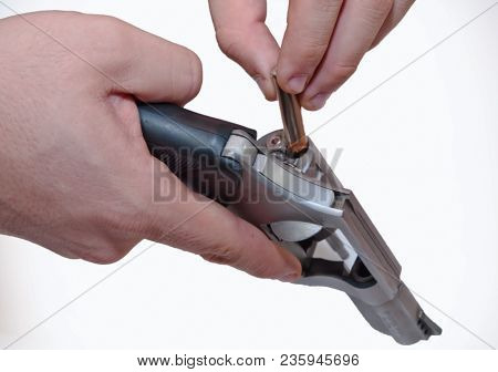 Two Hands Shown Loading A .357 Magnum Revolver