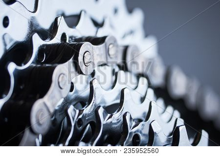 New Rear Mountain Bike Cassette With Chain On The Black Background Close Up, Studio Shot.