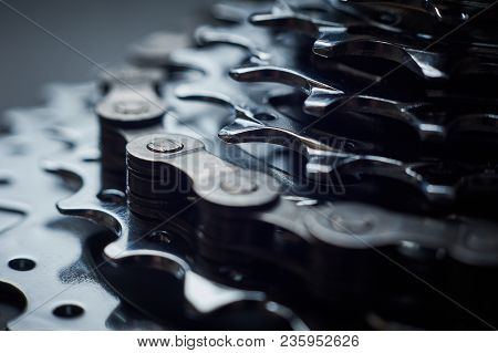 New Rear Mountain Bike Cassette With Chain On The Black Background Close Up, Studio Shot.