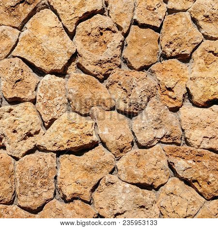Old Stone Wall With Ivy As Background. Decorative Facing Of The Outer Walls Of The House.