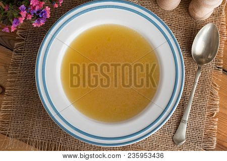 Chicken Bone Broth Served In A Soup Plate, Top View