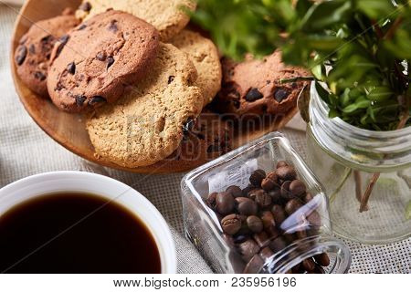 Side View Of A Plate Of Chocolate Chip Cookies On A White Plate Homespun Tablecloth Illuminated With