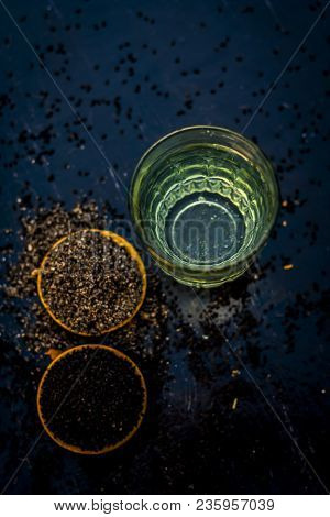 Close Up Of Kalonji Or Roman Coriander With Water And Honey On Wooden Surface Beneficial For Diabete