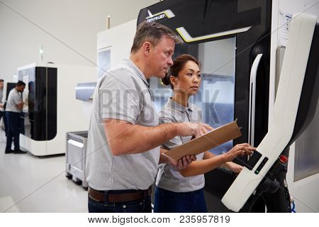 Engineer Training Female Apprentice To Use CNC Machine In Factory