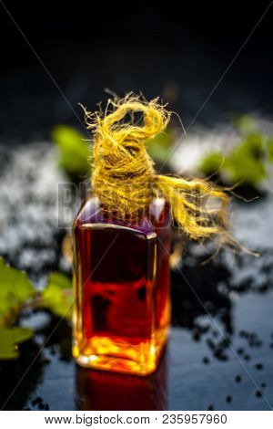 Close Up Of Kalonji, Roman Coriander, Mint Leaves, And Powder Of Kalonji With Its Extracted Oil For
