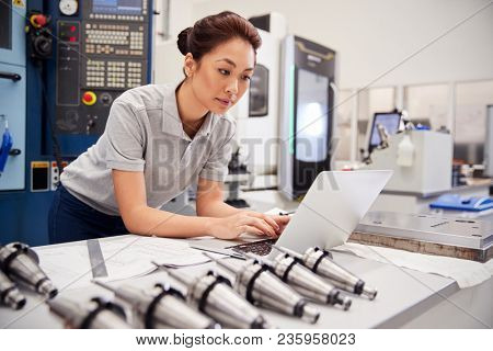 Female Engineer Using CAD Programming Software On Laptop