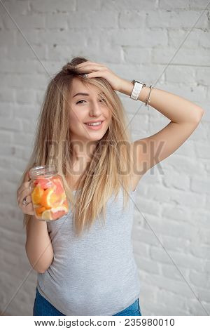 Caucasian Young Girl 20-25 Years Old Holding Bottled Glass Of Fresh Summer Lemonade With Straw.