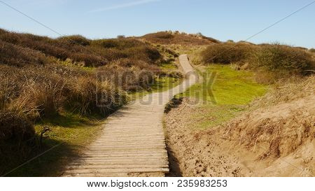 Boardwalk Path Leading Upwards Into The Distance Amongst Sand Dunes At Braunton Burrows, Devon, Engl