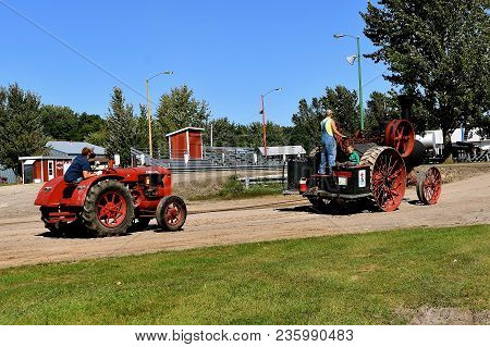 Dalton, Minnesota, Sept 8, 2017: An Old Advance Steam Engine Pulls A Mccormick Deering W 30 At The A