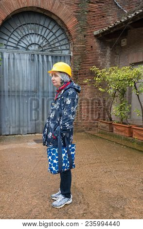 Senior Female Tourist Waiting By The Entrance To The Domus Aurea Excavation Site In Rome
