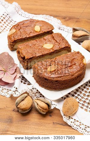 Fresh Baked Dutch Filled Spicy Cookies With Almonds In Autumn Colors On Dark Wooden Background