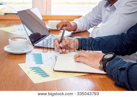 Two Businessmen Discussing And Planning Work At Cafe.
