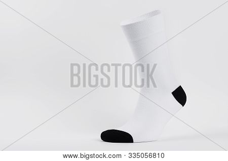 Blank White Cotton Long Sock With Black Heel On Invisible Foot On White Background As Mock Up For Ad