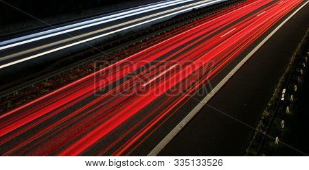 Interrupted Strips Of Light Due To A Bridge Railing