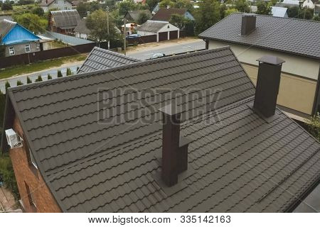 Modern Roof Made Of Metal. Corrugated Metal Roof And Metal Roofing. House With A Brown Metal Roof.