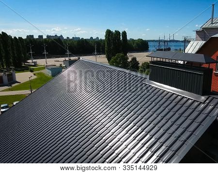 House With A Gray Metal Roof. Modern Roof Made Of Metal. Corrugated Metal Roof And Metal Roofing.
